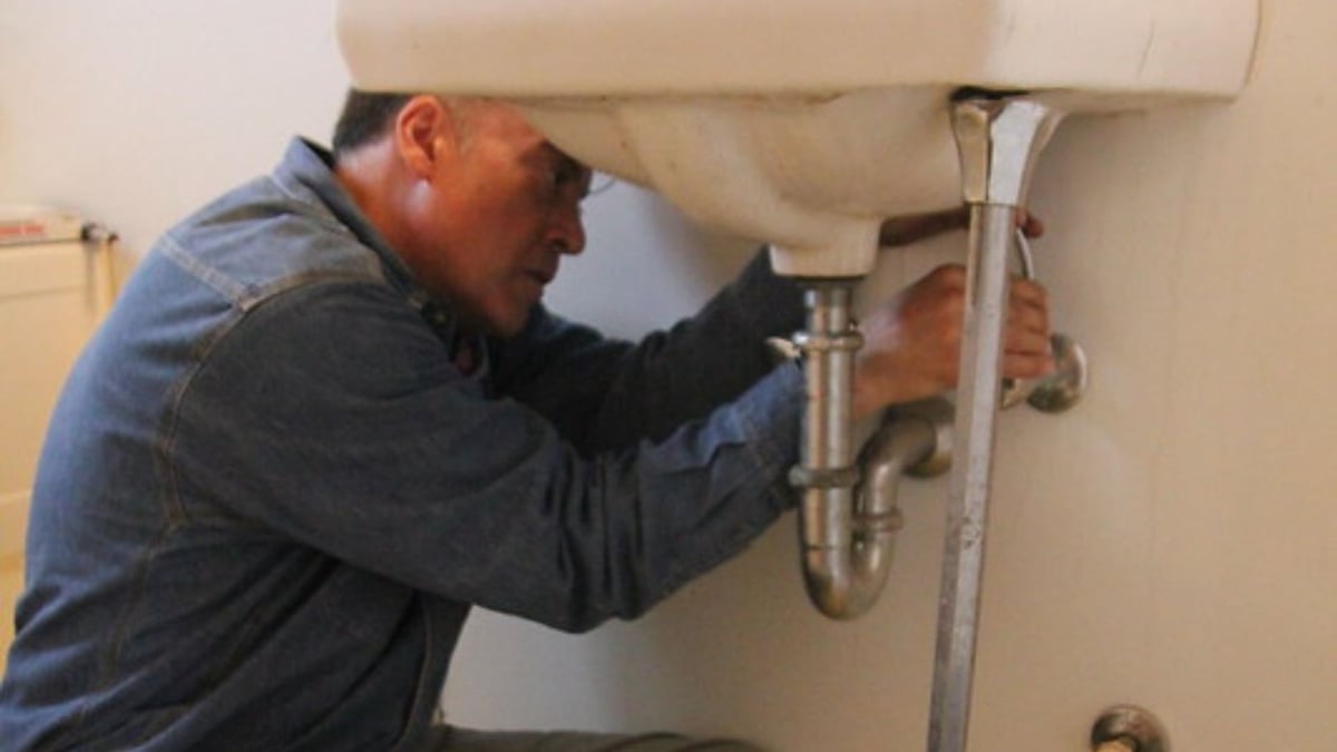 IWSH plumber working on sink drain